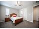 This bedroom features a ceiling fan, window shutters, and a wooden bedframe at 12018 Vento Forte Ave, Las Vegas, NV 89138