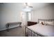 This bedroom features a ceiling fan, an ensuite bathroom, and a large desk at 12018 Vento Forte Ave, Las Vegas, NV 89138