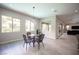 Breakfast nook with modern light fixture and views to the manicured front yard and garden at 12018 Vento Forte Ave, Las Vegas, NV 89138