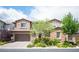 Charming two-story home featuring a brick facade, well-maintained landscaping, and a spacious three-car garage at 12018 Vento Forte Ave, Las Vegas, NV 89138