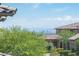 A scenic exterior view overlooking mature landscaping, rooftops, and a distant cityscape at 12018 Vento Forte Ave, Las Vegas, NV 89138