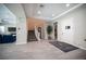 Inviting foyer with tile flooring, a staircase, and a view into the living room area at 12018 Vento Forte Ave, Las Vegas, NV 89138
