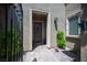 Inviting front entrance with a decorative gate, stylish lighting, and a charming welcome mat at 12018 Vento Forte Ave, Las Vegas, NV 89138