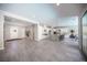 Open-concept space featuring a kitchen with white cabinets, an island, and gray tile floors at 12018 Vento Forte Ave, Las Vegas, NV 89138