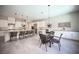 Open concept kitchen area with an island, chairs and a dining table at 12018 Vento Forte Ave, Las Vegas, NV 89138