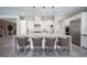 This modern kitchen features a central island with barstool seating, complemented by stainless steel appliances and sleek cabinetry at 12018 Vento Forte Ave, Las Vegas, NV 89138