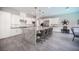 Elegant kitchen with white cabinetry, a large granite island, and seating for six at 12018 Vento Forte Ave, Las Vegas, NV 89138
