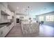 A gourmet kitchen features granite countertops, stainless steel appliances, and a spacious center island, ideal for culinary enthusiasts at 12018 Vento Forte Ave, Las Vegas, NV 89138