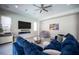 Well-lit living room boasting tile flooring, a comfortable sofa, recessed lighting, and a ceiling fan at 12018 Vento Forte Ave, Las Vegas, NV 89138