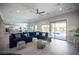 Spacious living room with stylish tile flooring, modern furniture, and access to the outdoor pool area at 12018 Vento Forte Ave, Las Vegas, NV 89138