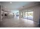 Open-concept living area with tile floors, recessed lighting, and seamless access to the kitchen and backyard at 12018 Vento Forte Ave, Las Vegas, NV 89138