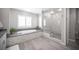 Elegant bathroom with soaking tub, frameless shower, and stylish fixtures at 12018 Vento Forte Ave, Las Vegas, NV 89138