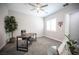 Bright home office featuring a large desk, gray carpet, shutters, and an elegant decorative tree and lots of natural light at 12018 Vento Forte Ave, Las Vegas, NV 89138
