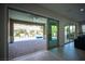 This covered patio features brick flooring and sliding glass doors with a view of the pool at 12018 Vento Forte Ave, Las Vegas, NV 89138