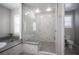 Elegant walk-in shower featuring marble walls and gray tile floor at 12018 Vento Forte Ave, Las Vegas, NV 89138