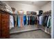 Walk-in closet featuring wood shelves, hanging rods and dresser at 12018 Vento Forte Ave, Las Vegas, NV 89138