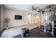 Well-equipped home gym with weight rack, TV, and plenty of space for activities at 12018 Vento Forte Ave, Las Vegas, NV 89138