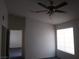 Bedroom showcasing a ceiling fan and window, with a glimpse into another room at 1401 N Michael Way # 244, Las Vegas, NV 89108
