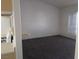 Living room featuring neutral carpet, white walls, and large window at 1401 N Michael Way # 244, Las Vegas, NV 89108