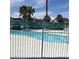 Community pool with surrounding iron fence and desert landscaping at 1401 N Michael Way # 244, Las Vegas, NV 89108