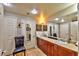 Bright bathroom with double sinks, wood cabinets, tile flooring, and decorative artwork at 150 Las Vegas Blvd # 1606, Las Vegas, NV 89101