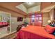 Comfortable bedroom with skylight, TV, wood floors, and views into living area at 150 Las Vegas Blvd # 1606, Las Vegas, NV 89101