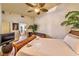 Comfortable bedroom features a large window, hardwood floors, ceiling fan, and view into the bathroom at 150 Las Vegas Blvd # 1606, Las Vegas, NV 89101