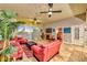 Open concept living room with tile flooring, red sofas, and picturesque city views from floor-to-ceiling windows at 150 Las Vegas Blvd # 1606, Las Vegas, NV 89101