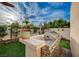 Backyard oasis featuring a built-in grill, lush greenery, and space for outdoor entertaining at 167 Thunder Plains Way, Henderson, NV 89012