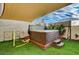 Backyard features a hot tub with surrounding green artificial grass for outdoor relaxation and fun at 167 Thunder Plains Way, Henderson, NV 89012