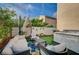 Inviting backyard featuring comfortable seating, a vibrant rug, and well-manicured greenery at 167 Thunder Plains Way, Henderson, NV 89012