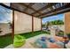 Charming backyard patio with pergola, turf, outdoor grill, and relaxed seating for entertaining at 167 Thunder Plains Way, Henderson, NV 89012
