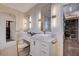Modern bathroom featuring dual sinks, marble countertops, gold fixtures, and walk in closet access at 167 Thunder Plains Way, Henderson, NV 89012