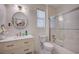 Bright bathroom with marble vanity, updated fixtures, toilet, and shower/tub with sliding glass doors at 167 Thunder Plains Way, Henderson, NV 89012