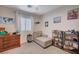 Bright bedroom with a daybed, neutral tones, playful decor, and a window with natural light at 167 Thunder Plains Way, Henderson, NV 89012