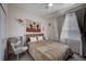Cozy bedroom featuring a comfortable bed, unique southwest themed wall decor, and a stylish accent chair at 167 Thunder Plains Way, Henderson, NV 89012