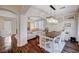 Open-concept dining room with modern chandelier, wood floors, and a view into the living room at 167 Thunder Plains Way, Henderson, NV 89012