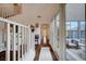 Inviting entryway with wood floors, white trim, and staircase leading to the second floor with a view of outdoor seating area at 167 Thunder Plains Way, Henderson, NV 89012