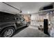 Spacious garage with ample storage cabinets, and a modern black SUV, providing secure parking at 167 Thunder Plains Way, Henderson, NV 89012