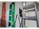 Well-organized garage featuring a Tesla charger, ladders, and shelving for efficient storage solutions at 167 Thunder Plains Way, Henderson, NV 89012