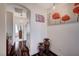 Hallway featuring hardwood floors, arched doorways, decorative vases, and artwork at 167 Thunder Plains Way, Henderson, NV 89012