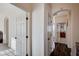Hallway featuring hardwood flooring, arched doorways, and white trim leading to other rooms in the home at 167 Thunder Plains Way, Henderson, NV 89012