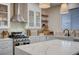 Bright kitchen featuring stainless steel appliances, white cabinets, and a spacious island at 167 Thunder Plains Way, Henderson, NV 89012