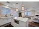 This kitchen features a white marble island, stainless appliances, and a modern farmhouse sink at 167 Thunder Plains Way, Henderson, NV 89012
