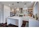 Well-lit kitchen with white cabinets, stainless steel appliances, a large center island, and pendant lighting at 167 Thunder Plains Way, Henderson, NV 89012
