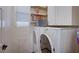 Functional laundry area with modern washer and dryer, plus convenient storage shelves and cabinets at 167 Thunder Plains Way, Henderson, NV 89012