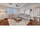 Spacious living room with comfortable seating, a ceiling fan, and access to the dining area at 167 Thunder Plains Way, Henderson, NV 89012