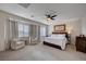 Spacious primary bedroom with sitting area, large windows, and neutral decor at 167 Thunder Plains Way, Henderson, NV 89012