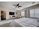 Bright primary bedroom with large bed, sitting area, and modern electric fireplace at 167 Thunder Plains Way, Henderson, NV 89012