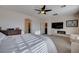 Bright primary bedroom with large bed, sitting area, neutral walls and modern fireplace at 167 Thunder Plains Way, Henderson, NV 89012